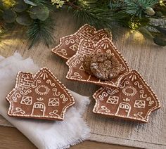 three gingerbread shaped cookies sitting on top of a table