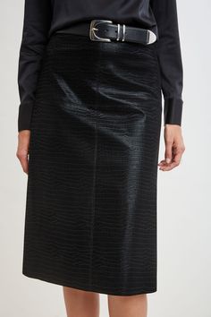 Make a statement in our Sueded Crocodile Embossed Midi Skirt. The slightly A-line silhouette is detailed with modern raw cut seaming. Perfectly paired with its matching blazer or motto jacket, this piece combines chic sophistication with an ultra-cool edge. Limited Edition 50th Anniversary Collection Elie Tahari Exclusive Crocodile Embossed Vegan Leather Midi Skirt 80% Polyurethane, 33% Viscose, 5% Other Runs true to Size Length From Waist to Hem: Back 29"L (approx. length for size 6) Model is 5 Black Pencil Skirt For Formal Fall Occasions, Black Pencil Skirt For Formal Fall Events, Formal Structured Spring Skirt, Motto Jacket, Tahari Dress, Leather Midi Skirt, Jumpsuit Jacket, Long Sleeve Short Dress, Black Midi Skirt