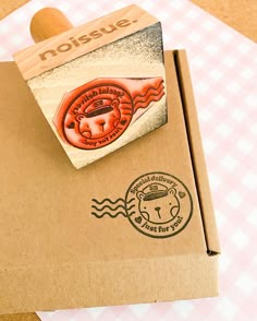 a rubber stamp on top of a cardboard box