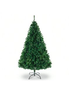 a small green christmas tree sitting on top of a metal stand