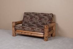 a couch made out of logs and fabric sitting on top of a carpeted floor