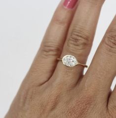 a woman's hand with a diamond ring on it