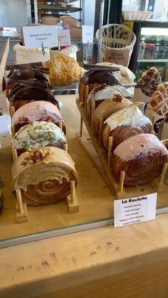 an assortment of pastries on display in a bakery