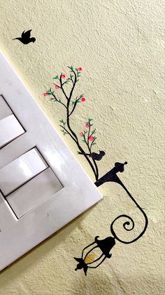 an electrical outlet cover with birds and flowers painted on the wall next to it's light switch