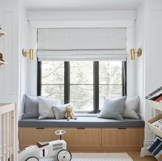 a child's room with a window seat and toys