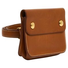 Hermès pouch on belt, Floride model, in Barenia leather (natural camel color) composed of a simple pouch closed with 2 "Clou de selle" motif snaps in gold metal and a matching belt to slip into the back of the pouch and adjustable by its double rings. Pouch: width 14 cm x height 10 cm x depth 4 cm - belt: total length 100 cm x width 1.3 cm. The belt pouch has been worn and the leather has slight nail marks here and there but the whole is in very good condition, signature leather, emblematic and collector's model. Hermes Clutch, Simple Pouch, Double Rings, Belt Leather, Belt Pouch, Chatelaine, Double Ring, Camel Color, The Pouch