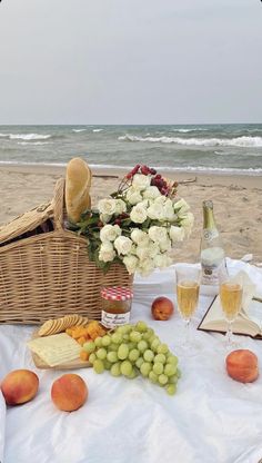 a picnic on the beach with wine, cheese and fruit