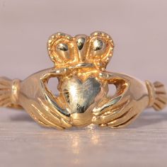 The Limerick: Classic Claddagh Ring In Yellow Gold. This Classic Claddagh Ring Features A Polished Heart At The Center, Topped With A Crown And Flanked By Traditional Hands On Either Side. Crafted In Yellow Gold, The Ring Is Currently A Size 6 But Can Be Resized To Fit Any Finger For An Additional Fee Upon Request. Yellow Gold Color, Claddagh Ring, Claddagh Rings, 6 Rings, Gold Yellow, Womens Jewelry Rings, Hands On, Gold Color, Yellow Gold