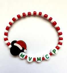 Are you attending MVMCP? This beaded stretch bracelet with glass seed beads in a red and white candy cane pattern are finished off with a super cute mouse ears Santa hat charm.  Bracelets are available in a variety of lengths.  Pick your custom length from the drop down menu below.  Please be aware that beading may slightly differ from what is pictured as to accommodate selected sizing.  All our bracelets are made with quality in mind.  With that being said, all bracelets should be treated with Disney Bracelets, Christmas Party Theme, Candy Cane Pattern, Disney Bracelet, Very Merry Christmas Party, Disney World Outfits, Christmas Party Themes, Word Bracelet, White Candy