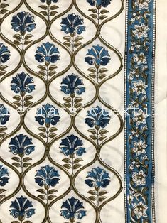 a blue and white cloth with flowers on it's border, in an ornate pattern