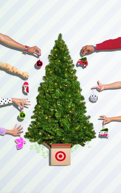 several hands reaching out towards a christmas tree