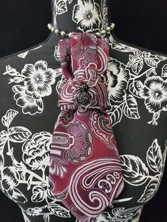 This Burgundy and White Paisley Necktie Necklace is made with a woven silk tie, and features a Black Rhinestone Spider Brooch strung on your choice of an adjustable Rosary Chain Ribbon Tie Pearl Necklace or an adjustable Elastic Band. The soft, comfortable fabric sits perfectly on any size chest, while the adjustable necklace feature allows you to customize the fit to your liking. Measuring at a versatile length, this necktie necklace is designed to be a one-size-fits-all. View all Women Tie's: Elegant Adjustable Neckwear For Gifts, Elegant Adjustable Neckwear As Gift, Elegant Adjustable Neckwear As A Gift, Elegant Red Neckwear For Gift, Elegant Red Neckwear As A Gift, Elegant Burgundy Tie For Formal Occasions, Elegant Adjustable Red Neckwear, Elegant Red Adjustable Neckwear, Elegant Adjustable Formal Neckwear