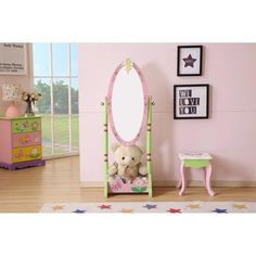 a teddy bear sitting in front of a mirror on top of a wooden floor next to a pink wall