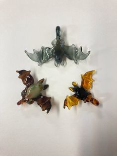 Flameworked borosilicate glass bats with loops. Each hangs upside down with wings outstretched from a loop at their feet with an inner diameter of ~3mm. Bat Upside Down, Glass Blowing Art, Glass Trinkets, Glass Accessories, Sculptural Jewelry, Glass Craft, Glass Sculptures, Glass Charms