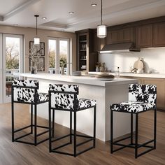 three chairs sitting in front of a kitchen island