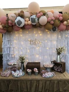 a table topped with lots of balloons and desserts next to a sign that says 360