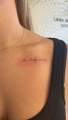 the back of a woman's shoulder with an inscription on it