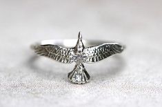 This listing is for one sterling silver thunderbird stacking ring.  I love the detail of these majestic hawk rings and feel connected to all of the birds of prey that I love so much when I wear it.  It features one detailed sterling silver hawk fired onto a 14 gauge sterling silver ring band.  This delicate hawk even has cute little feet on the inside. Wear this bohemian ring to show your affinity and love for all things natural, spiritual, and sky-bound. It is a powerful and eye-catching piece. Stacked Rings Boho, Jeweled Bag, Pandora Gold, Eagle Ring, Stackable Rings Silver, Silver Eagle, Diamond Stacking Rings, Silver Eagles, Gold Jewelry Simple