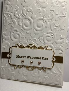 a white wedding card with gold trimming