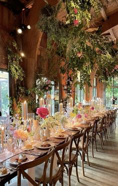 a long table is set up with flowers and candles for an elegant dinner or party