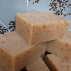 several pieces of soap stacked on top of each other in front of a blue and brown wall