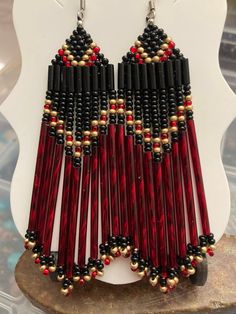 a pair of red and black beaded earrings