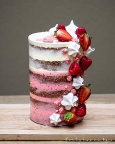 a pink and white cake with strawberries on top is displayed in an instagram