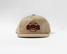 a baseball cap with the word giants on it and a ball in the center that says,