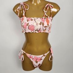 This Floral Smocked Print Bikini Set Includes A Bandeau Top With Allover Smocking And Ruffled Hems. It Features Removable Soft Cups And Straps That Tie At The Shoulders For A Custom Fit. The Bottoms Have Tie Sides And A Scrunchy Back For Moderate Coverage. Made From Super Soft Microfiber Materials For Ultimate Comfort. Sleeveless Swimwear With Smocked Bodice For Vacation, Spring Beach Party Swimwear With Smocked Bodice, Stretch Sleeveless Swimwear With Smocked Bodice, Sleeveless Stretch Swimwear With Smocked Bodice, Beachy Fitted Swimwear With Smocked Bodice, Vacation Swimwear With Smocked Bodice For Beach Season, Stretch Swimwear With Smocked Bodice For Vacation, Fitted Swimwear With Smocked Bodice For Beach, Fitted Smocked Bodice Swimwear For Beach