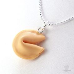 Looking for a unique way to wish someone goodluck? Express your well wishes with our Scented Fortune Cookie Necklace, which symbolizes prosperity in the future. The unique design of this cute jewelry centers on a 3/4-inch charm hand-shaped out of polymer clay to look identical to a real fortune cookie. Adding to the effect is a delectable Delicious Sugar Cookie scent, which comes from potent fragrance oils that are added to the clay. The necklace arrives ready to wear, attached to a sterling sil Unique Charms Necklace For Good Luck, Unique Charm Necklace For Good Luck, Nickel-free Novelty Pendant Necklaces, Nickel-free Novelty Pendant Necklace, Novelty Nickel-free Pendant Necklace, Nickel-free Cute Jewelry For Gifts, Silver Novelty Necklace For Gift, Personalized Novelty Pendant Jewelry, White Good Luck Charm Necklaces