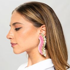 Step out in style with these Pink Gold statement Wing Earrings - a perfect balance of cuteness and elegance. Women will love the unique combination of whimsy and luxury with the playful baby pink hue and opulent golden tones. The one-of-a-kind earrings are designed in the shape of angel wings, adorned with layers of sequins arranged around a single stud. Be a true statement-maker with these handmade, beaded statement earrings. Size: Length: 3.5''/ Width: 1'' Drop Earrings For Spring Party, Spring Party Drop Earrings, Glamorous Party Earrings For Spring, Glamorous Spring Party Earrings, Handmade Earrings For Spring Party, White Beaded Earrings For Spring Party, Pink Chandelier Earrings For Summer Party, Whimsical Spring Earrings For Pierced Ears, Trendy Pink Gold Jewelry For Party