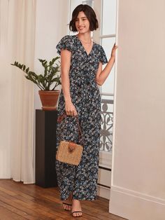 Achieve a timelessly chic look with this Floral Print Belted Wide Leg Jumpsuit. Decorated with a beautiful floral print all over in a black shade, this sophisticated one-piece features a comfortable, flowy fit and a fashionable belted waist, perfect for making a stylish statement. Indulge in the luxury of this timelessly elegant and tasteful ensemble today. Specifications: Color: Black Style: Boho Pattern Type: Floral, All Over Print Type: Wide Leg Details: Ruffle, Wrap Length: Long Fit Type: Regular Fit Neckline: V neck Sleeve Length: Cap Sleeve Sleeve Type: Butterfly Sleeve Waist Line: High Waist Fabric: Non-Stretch Material: Woven Fabric Composition: 100% Polyester Care Instructions: Machine wash or professional dry clean Body: Unlined Belt: Yes Sheer: No Size Chart(cm): Size Belt Lengt Summer Floral Print Maxi Jumpsuits And Rompers, Chic Floral Print Maxi Jumpsuits And Rompers, Chic Floral Print Jumpsuits And Rompers For Beach, Casual Belted Maxi Dress For Vacation, Chic Beach Jumpsuit With Floral Print, Casual Floral Print Maxi Jumpsuits And Rompers, Chic Floral Print Beach Jumpsuit, Casual Flowy Jumpsuits And Rompers With Floral Print, Casual Flowy Floral Print Jumpsuits And Rompers