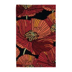 an orange and black rug with flowers on it