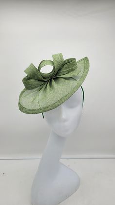 "Elegant mint/light/moss green sinamay fascinator adorn with flowers and feathers. Very light weight and it sits on a 1.5\" wide headband. - Rare find - Ready to ship  - Lightweight - Free Shipping - Fast shipping - Customize by adding different color flowers and or feathers Check my store for for styles and colors.  Hatsandpearls.etsy.com Find more at my website for more styles: www.hatsandpearls.com  Reach out to me if you can't find what you are looking for.  I can make cake custom orders and help you style and match your outfit  Tag and share your pictures when you wear and style our hats.  Instagram: @hats_pearls Facebook: Hats Pearls Thank you for visiting!" Luxury Green Headpiece For Kentucky Derby, Luxury Green Summer Fascinator, Sinamay Fascinator Hat For Spring, Spring Sinamay Fascinator Hat, Spring Sinamay Fascinator, Green Straw Hat With Short Brim, Green Brimmed Straw Hat For Garden Party, Spring Sinamay Mini Hats For Races, Adjustable Green Brimmed Boater Hat