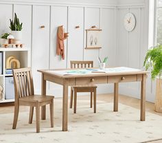 a wooden table and two chairs in a room