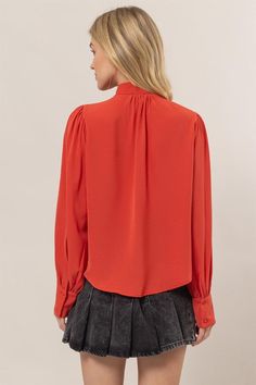 Get ready to add some playful flair to your wardrobe with our Ruffles Blouse! Featuring long balloon sleeves with buttoned cuffs, a pretty tie-neck, and gentle ruffles at the front, this blouse brings fluttery movement to any outfit. The button-down bodice offers a classic fit and ends with a rounded hem for a stylish touch. 100% Polyester Chic Button-up Puff Sleeve Top For Fall, Billowy Solid Color Blouse With Lantern Sleeves, Chic Fall Blouse With Balloon Sleeves, Fall Blouse With Pleated Sleeves And Ruffled Collar, Fall Office Puff Sleeve Top With Lantern Sleeves, Fall Lantern Sleeve Blouse With Button Closure, Fall Lantern Sleeve Puff Top For Office, Workwear Blouse With Ruffles And Balloon Sleeves, Office Puff Lantern Sleeve Top For Fall