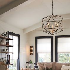 a living room filled with furniture and windows