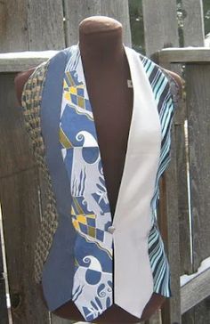 a mannequin wearing a blue and white neck tie with an elephant on it