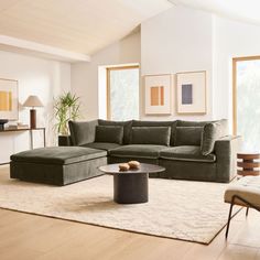 a living room filled with furniture and a large rug on top of a hard wood floor