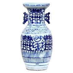 a blue and white vase sitting on top of a table