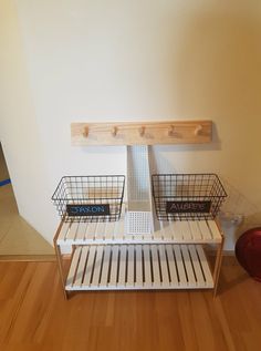 two baskets are stacked on top of each other in front of a wall mounted shelf