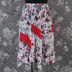 Gorgeous flower pattern asymmetric summer skirt. Size S Elastic waist: 24-26 inch / 61-66 cm Length: 24 inch / 61 cm Please note that all things we're selling here are several decades old might show minor signs of wear even from being stored in warehouses for such a long time. However everything we sell is in fair good vintage condition or very close to that and if we spot any minor imperfections, we list them in description as precisely as possible.  We may miss some discrepancies due to human error but i do try my best to always thoroughly check items!  Please see all pics before making your choice. Summer Patchwork Midi Skirt, Summer Patterned Lined Skirt, Summer Floral Print Skirt With Asymmetrical Hem, Summer Patchwork Maxi Skirt, Patterned Summer Skirt, Summer Patterned Skirt, Summer Patterned Bottoms With Lined Skirt, Spring Floral Print Asymmetrical Skirt, Patterned Long Summer Skirt