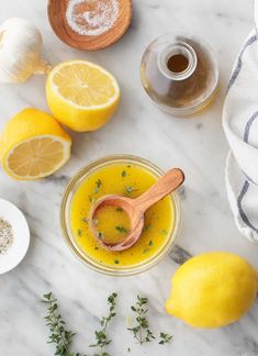 lemons, garlic and other ingredients on a marble table