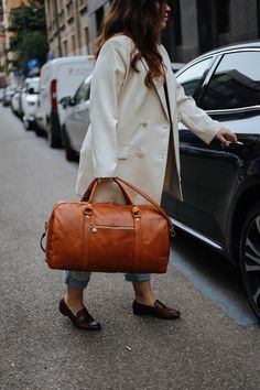 This handmade leather travel bag is made with 100% natural full grain leather which is tanned with all natural materials. There is no chemical materials in this leather.  This bag is handmade in our studio in Milan.  The lining is 100% cotton and it is easy to clean.  All the HARDWARE are made by BRASS. they are real brass and not finishing by brass color. the quality is really high and we guarantee all of the hardwares. All the bags will come with a cotton dust bag which can protect the leather and bag when it is not in use.  In options u can find Protection cream to add to your purchase. It will make the bag waterproof and will renew it after some use.  Dimensions :  Wide: 52 Cm / 21  inches Hight: 29 Cm / 11.5 inches  Deep: 26 Cm / 10.5 inches  Handle drop: 15 Cm / 6inches Long adjustab Leather Overnight Bag, Leather Duffel Bag, Leather Duffel, Sac Week End, Leather Duffle Bag, Leather Travel Bag, Leather Duffle, Bags Aesthetic, Travel Duffel