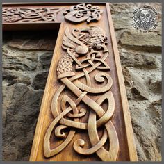 an intricate wooden carving on the side of a building