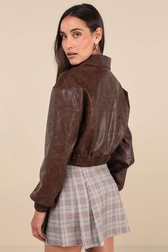 Hit the road looking cuter than ever in the Lulus Iconic Travels Brown Vegan Leather Cropped Bomber Jacket! Pebbled faux leather, with distressed fading throughout, shapes this stylish jacket with a collared neckline and long sleeves with drop shoulders and fitted elasticized cuffs. An exposed silver zipper secures at the front of the cropped bodice that boasts two, seamed zippered front pockets. Classic, elasticized banded hem completes the look. Pair with the matching skort for a complete look Brown Collared Leather Jacket For Spring, Trendy Collared Biker Jacket For Fall, Trendy Faux Leather Collared Jacket, Trendy Faux Leather Cropped Jacket For Fall, Trendy Brown Cropped Jacket For Fall, Spring Collared Faux Leather Outerwear, Spring Collared Leather Jacket, Trendy Collared Biker Jacket For Spring, Trendy Collared Faux Leather Outerwear