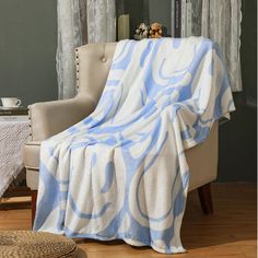 a blue and white blanket sitting on top of a chair