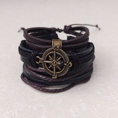 Embrace the allure of the unknown and showcase your adventurous side with our Multilayer Compass Pirate Bracelet. With its striking design and adjustable size, this accessory invites you to chart your own course in style. So, set sail on a journey of self-expression and discovery. Product Information *Set contains 3 separate bracelets *Adjustable length:       7 - 8.5 inches (fits most adults)      6 inches  *Metals Type: alloy *Materials: faux leather, leather *Adjustable: Sliding lock *Men's, Pirate Jewelry Bracelets, Pirate Accessories Men, Pirate Accessories Aesthetic, Ren Fest Jewelry, Pirate Aesthetic Jewelry, Pirate Clothes Aesthetic, Pirate Trinkets, Pirate Accessories Women, Black Bracelet Jewelry For Outdoor