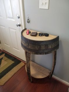 a wooden table sitting on top of a hard wood floor next to a white door