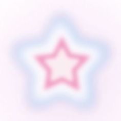 a pink and blue star on a white background with some blurry light around it